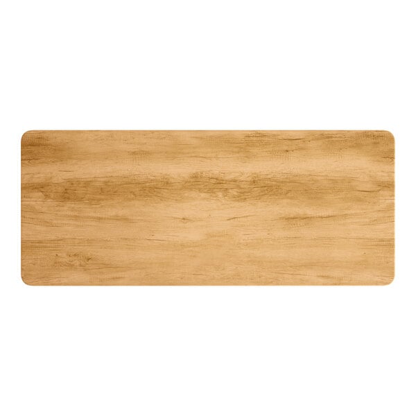 A close-up of a rectangular wood table top with a maple finish.