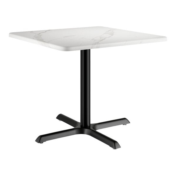 A white square table with a white marble surface and black base.