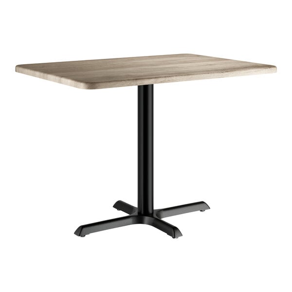A rectangular standard height table with a gray wood finish top and a black metal pedestal base.