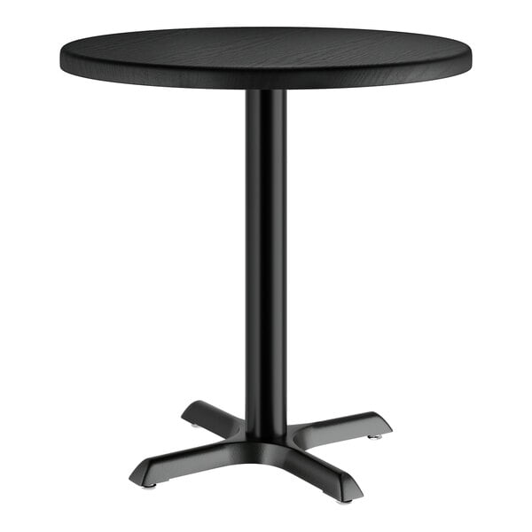 A Lancaster Table & Seating round black table with a metal leg.