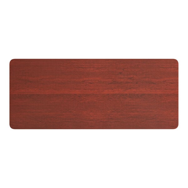A rectangular wooden table top with a red mahogany finish.