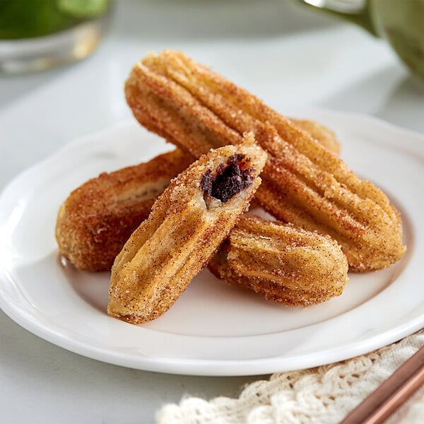 White Toque chocolate hazelnut filled churros on a plate.
