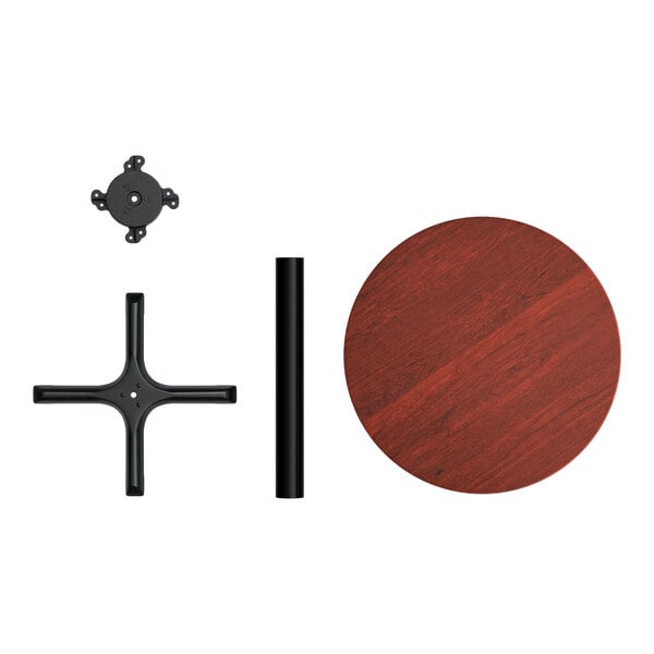 A Lancaster Table & Seating round table with a red mahogany finish on a black metal base.