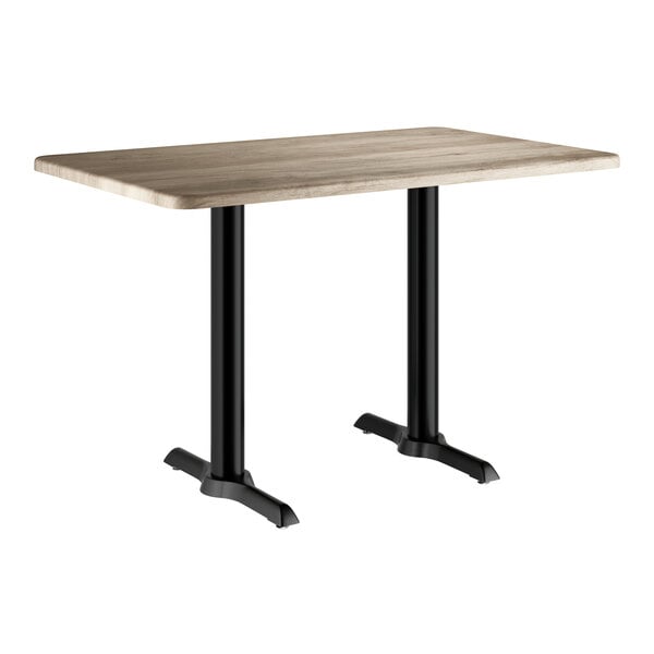 A rectangular standard height table with a gray wood finish top and black metal legs.