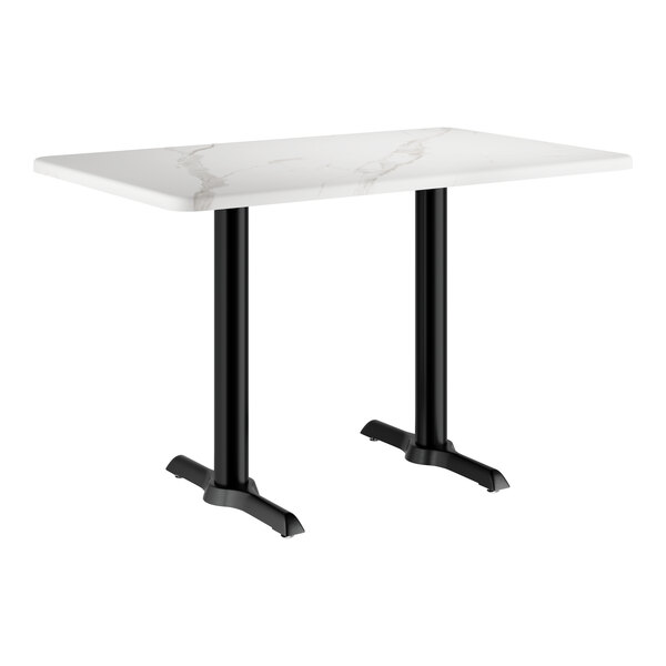 A white rectangular table with a white marble finish and black legs.