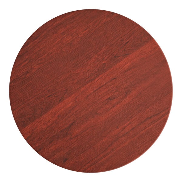 A Lancaster Table & Seating round wooden table top with a red mahogany finish.