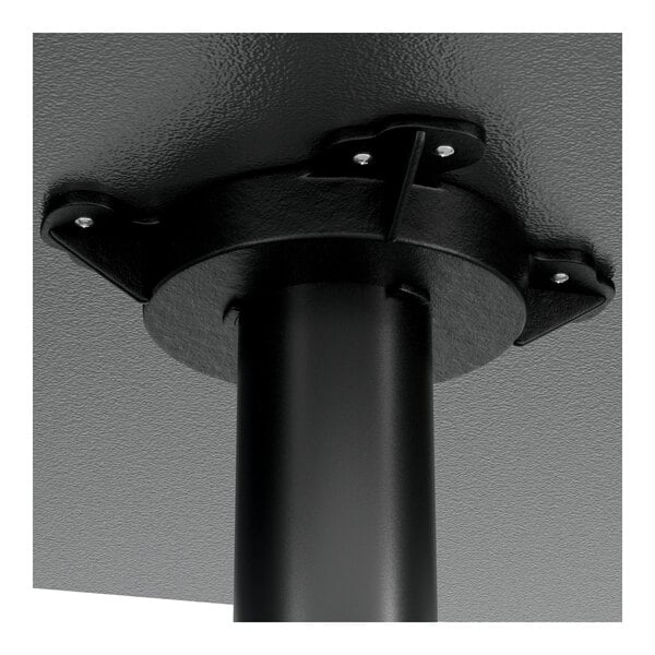 A black metal pole with a black metal base on a table.