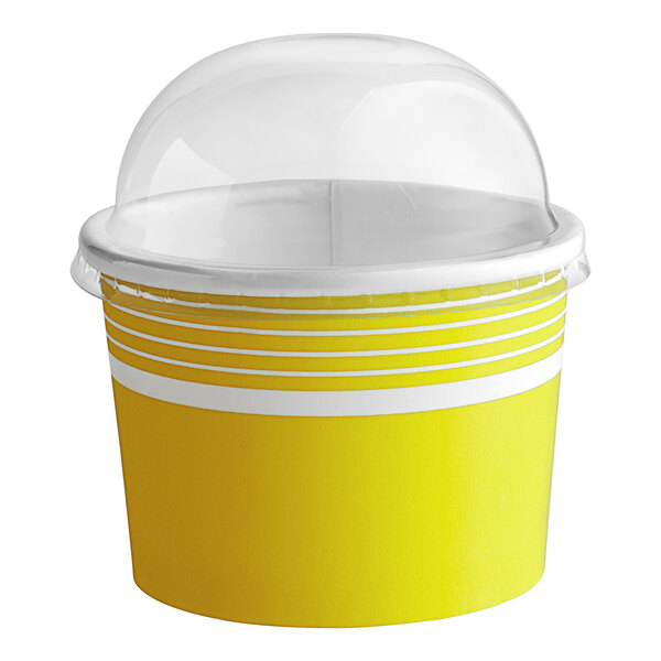 A yellow and white Choice paper frozen yogurt cup with a clear dome lid.