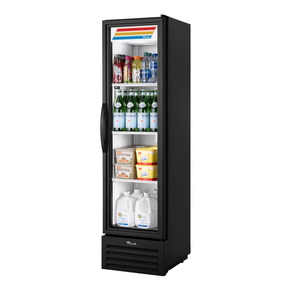 A black True reach-in refrigerator with shelves holding bottles and containers.