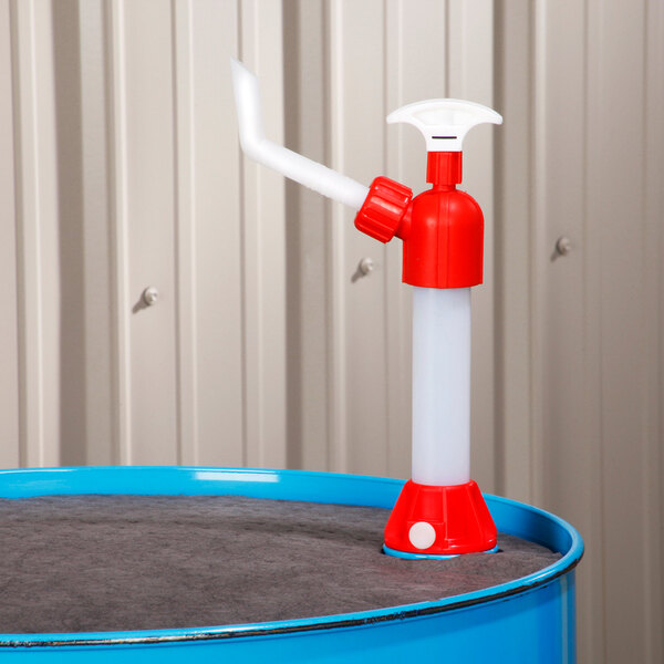 A red and white nylon piston hand drum pump mounted on a blue drum.