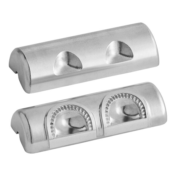 Two silver metal semi-circle dies with holes on metal bars.