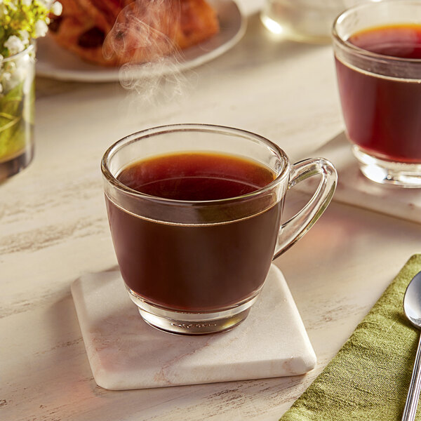 A glass cup of Green Mountain Coffee Roasters Dark Magic coffee on a table.