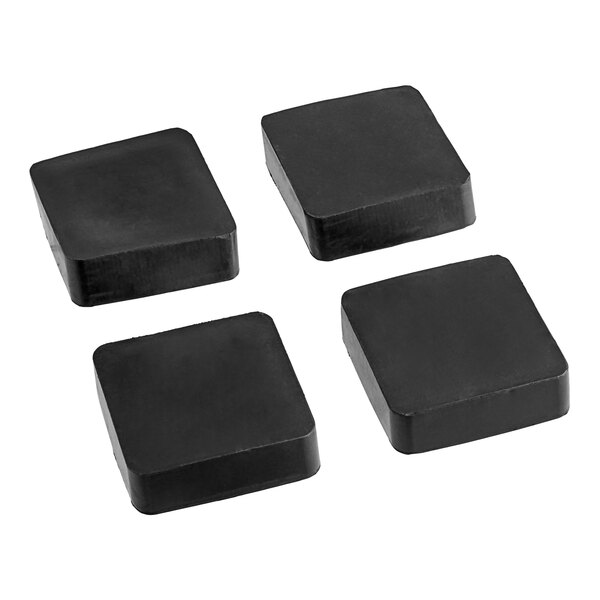 A black square block of rubber with four black square pads.