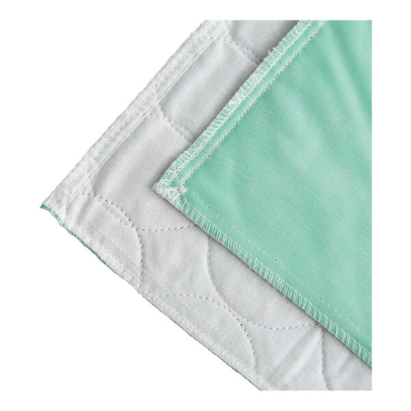 A green and white quilted mattress pad with a white border.
