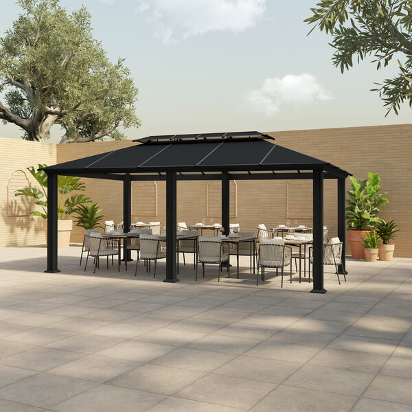 A black metal Paragon Outdoor Santa Monica gazebo with green plants in pots on a patio with tables and chairs.