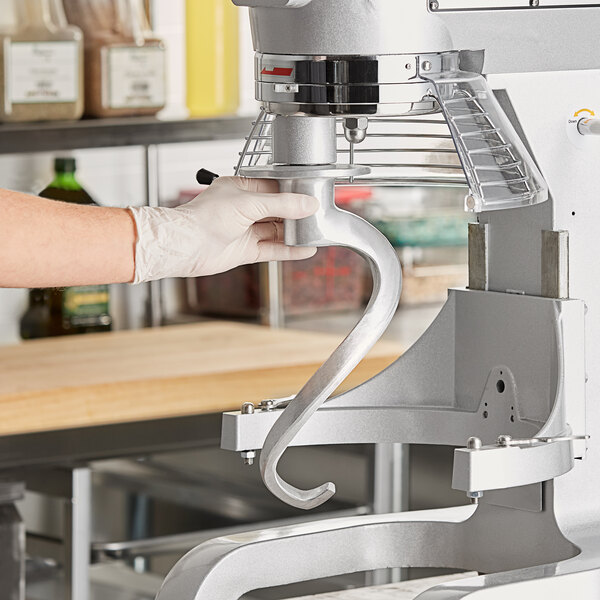A person using a MainStreet Equipment dough hook on a Galaxy mixer.