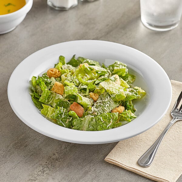 A white Acopa Foundations melamine salad bowl filled with a salad.