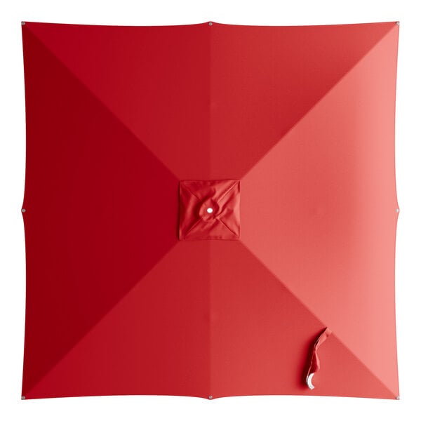 A red square umbrella canopy with a white circle in the center.