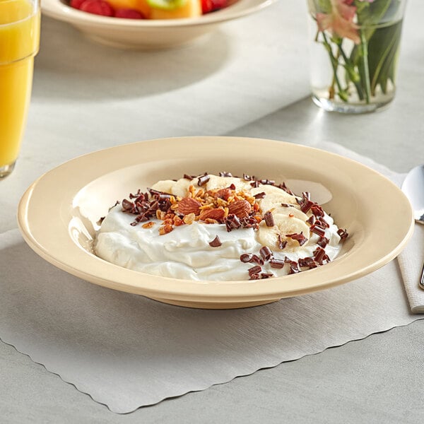 A tan Acopa Foundations melamine bowl filled with yogurt, fruit, and nuts.