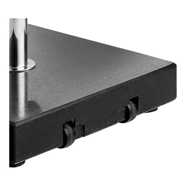 A black square granite base with a metal pole for an umbrella.