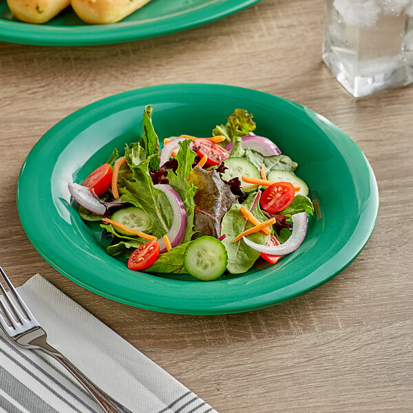 A green plate with a salad on it.