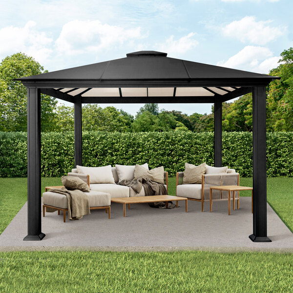 A patio with a black Paragon Outdoor Santa Monica gazebo and white furniture.