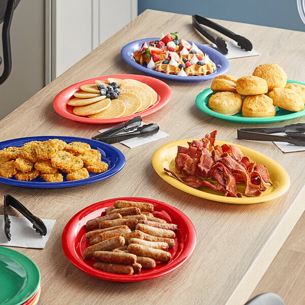 An Acopa Foundations assorted color melamine platter with food on a table.