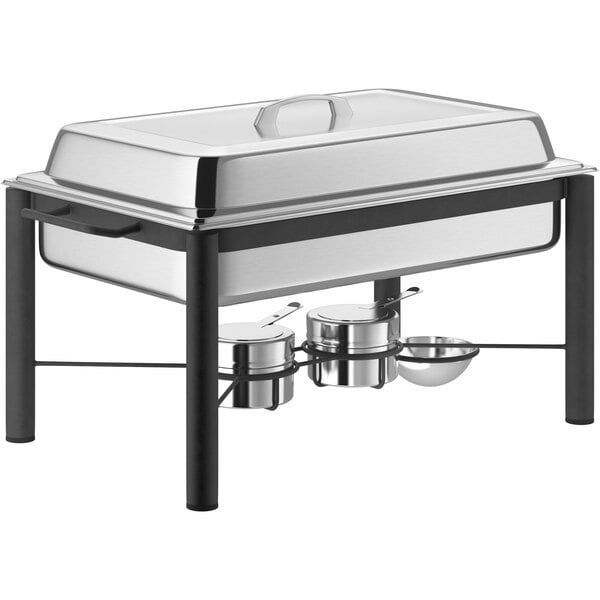 An Acopa wrought iron chafing dish with a stainless steel lid on a table.