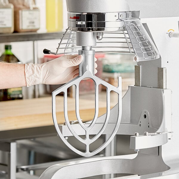 A hand using a Main Street Equipment flat beater attachment on a Galaxy mixer.