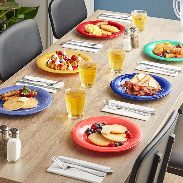 A table with Acopa Foundations melamine plates of food and drinks on it.