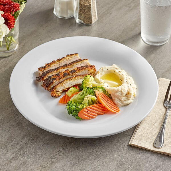 An Acopa Foundations white melamine plate with meat and vegetables on it