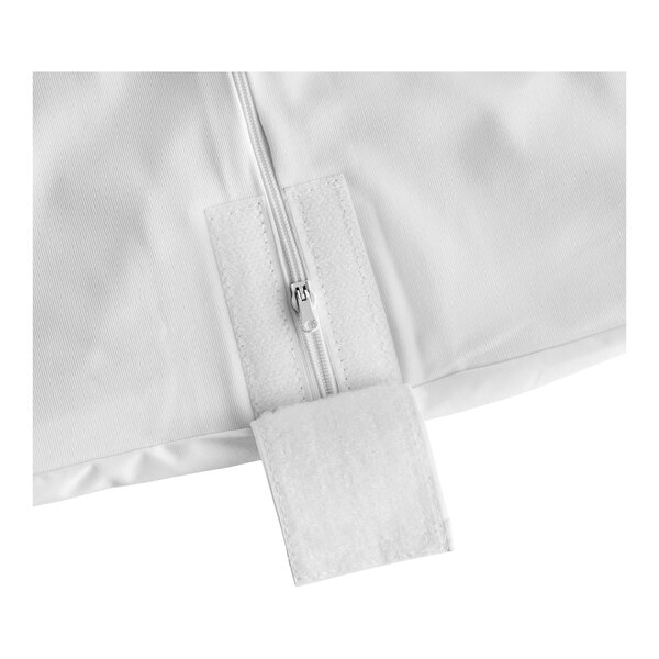A close-up of a zipper on a white mattress pad bag.