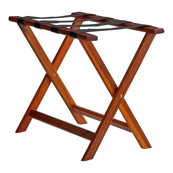 A Lancaster Table & Seating walnut wood folding luggage rack with black straps.