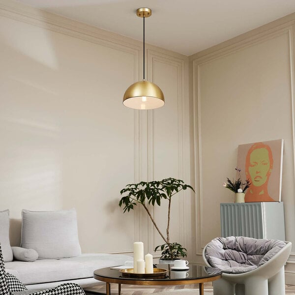 A living room with a white couch and a Globe Novogratz Retro Matte Brass pendant light.