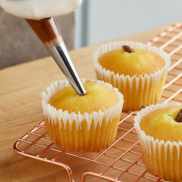 A cupcake with a piped filling using a Wilton Bismark piping tip.