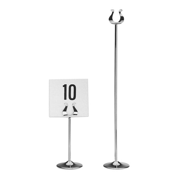 A Hepp silver-plated stainless steel table card holder with a white sign on a table.