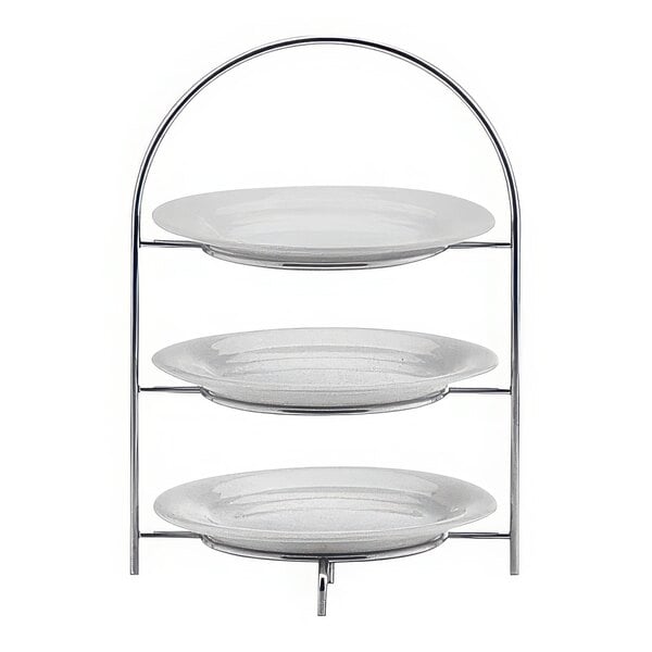 A Hepp by BauscherHepp stainless steel three tiered display stand with plates on it.