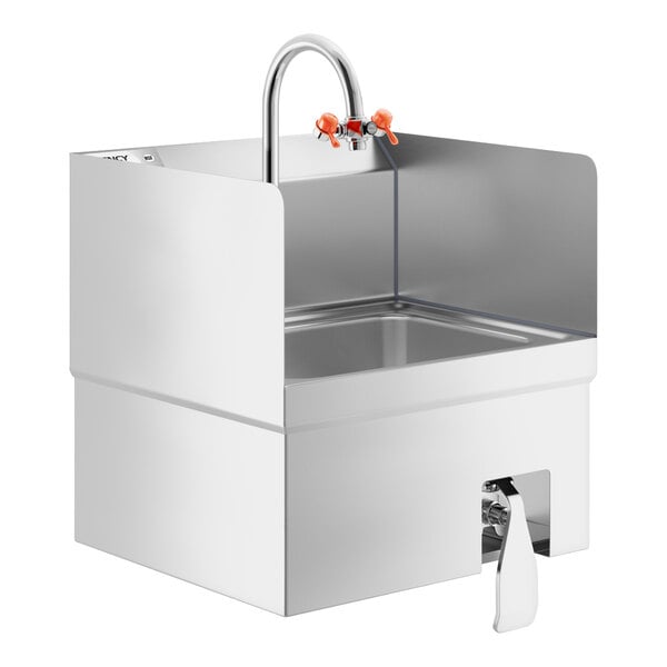 A stainless steel wall-mounted hand sink with side splashes, a gooseneck faucet, orange eyewash attachments, and a knee-operated valve.