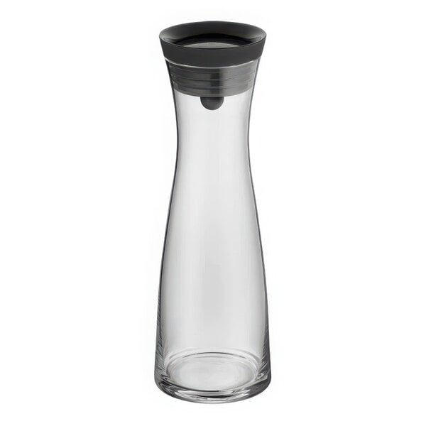 A clear glass carafe with a black top.