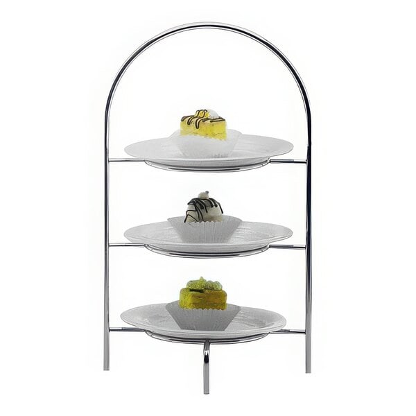 A Hepp by Bauscher stainless steel three tiered display stand with desserts.
