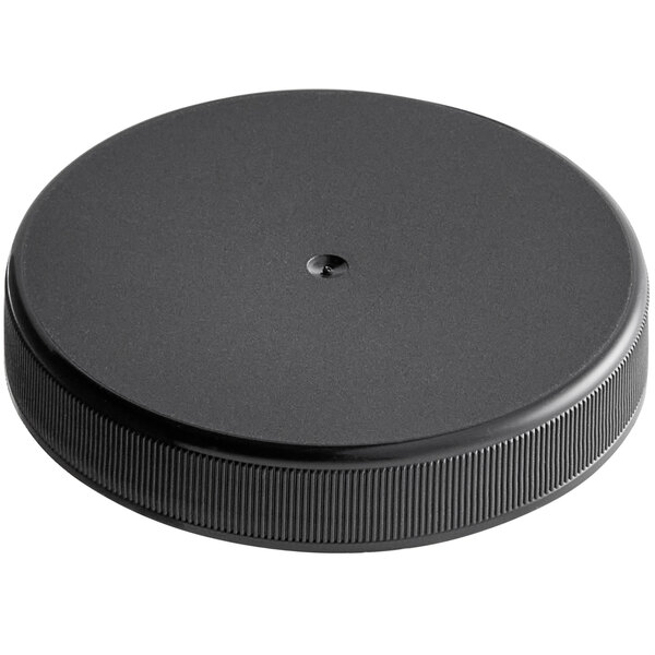 A 63/400 black plastic cap with ribbing and a hole in the middle.