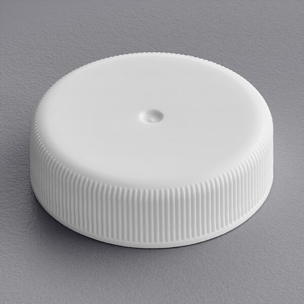 A 38/400 white plastic bottle cap with a heat induction foil liner.