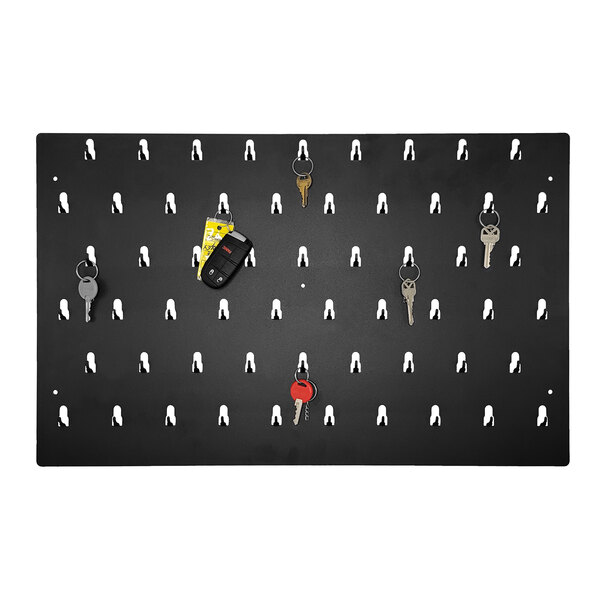 A black and white Pyramid Time Systems key rack with hooks holding keys on a wall.