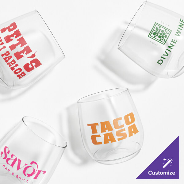 A set of four clear customizable plastic wine glasses, each with different printed logos and text.