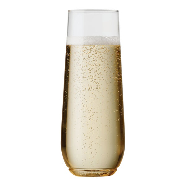 A close up of a Tossware plastic champagne flute full of champagne with bubbles.