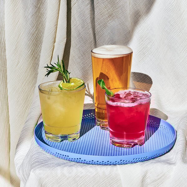 A group of Tossware Reserve Backbar Tritan plastic drinks on a blue tray.