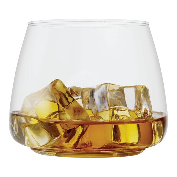 A Tossware plastic rocks glass filled with ice and amber liquid.