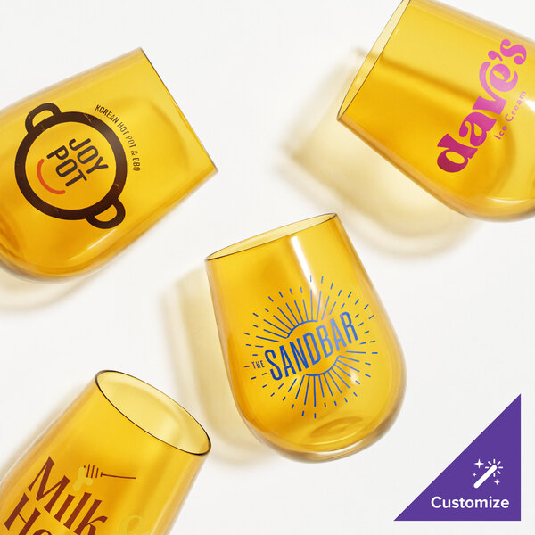 A yellow Tossware container with customised amber Tritan plastic stemless wine glasses inside.