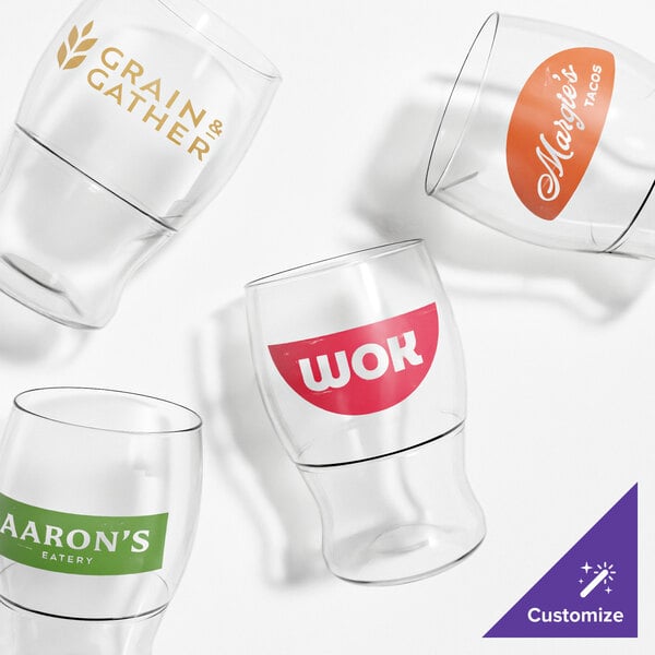 A group of Tossware taster glasses with different colored labels on a white background.