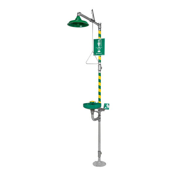 A green and yellow Haws emergency shower stand with a green hose.